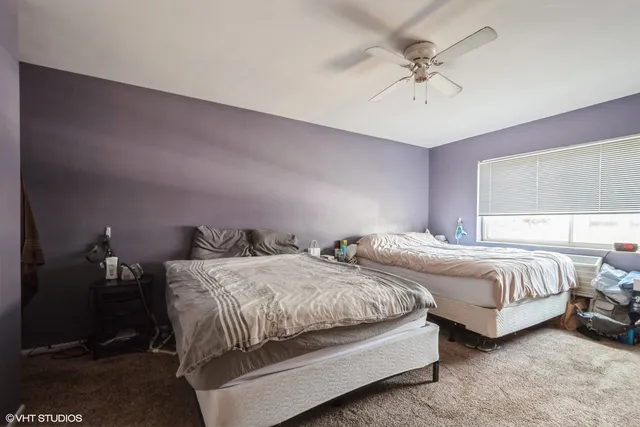 a bedroom with two beds and a chandelier