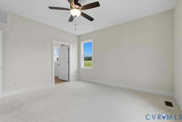 an empty room with chandelier fan