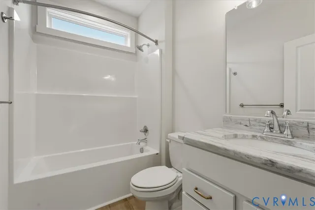 a bathroom with a granite countertop toilet a sink and a bathtub