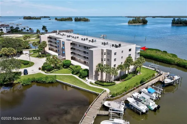an aerial view of a house with a lake view