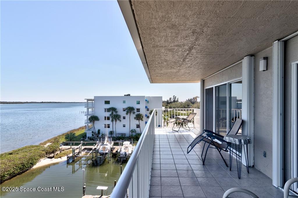 6061 North River Run Drive, Unit 6061 Sebastian, FL 32958 - Photo 13 of 36 a view of a balcony with chairs