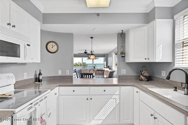 a kitchen with a sink cabinets and window