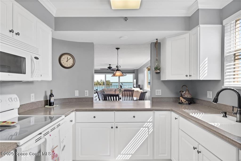 6061 North River Run Drive, Unit 6061 Sebastian, FL 32958 - Photo 17 of 36 a kitchen with a sink cabinets and window