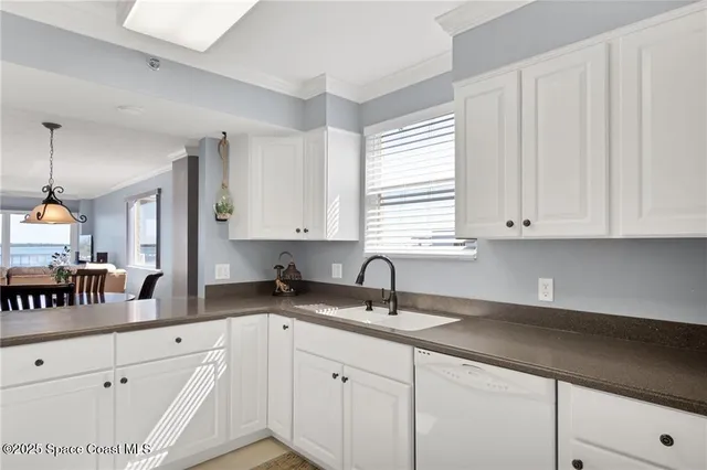 a kitchen with white cabinets and a sink