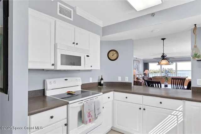 a kitchen with a stove and a white cabinets