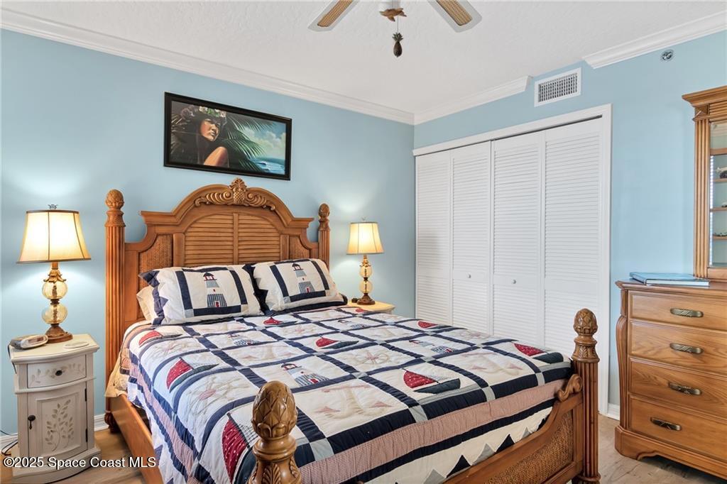 6061 North River Run Drive, Unit 6061 Sebastian, FL 32958 - Photo 26 of 36 a bedroom with a bed and lamp