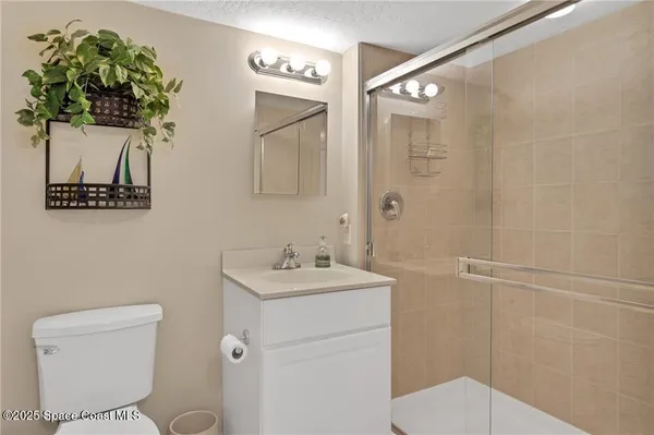 a bathroom with a toilet sink and shower