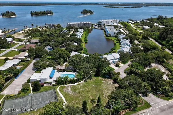 an aerial view of a house with a yard