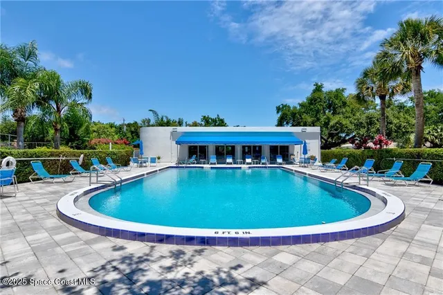 a view of swimming pool with seating space
