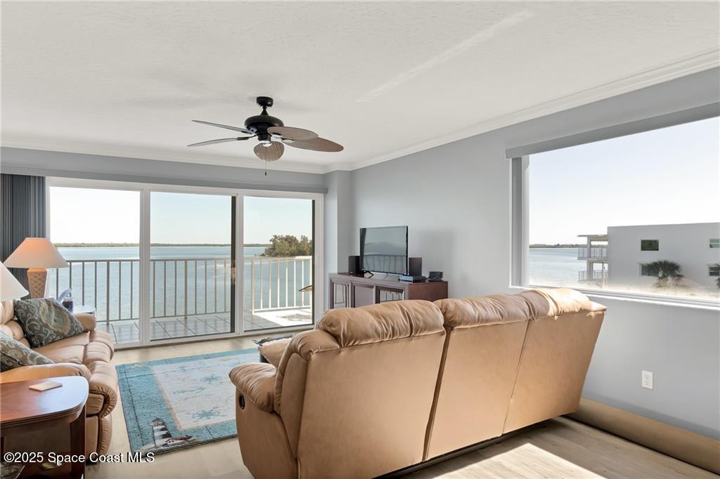 6061 North River Run Drive, Unit 6061 Sebastian, FL 32958 - Photo 6 of 36 a living room with furniture and a large window