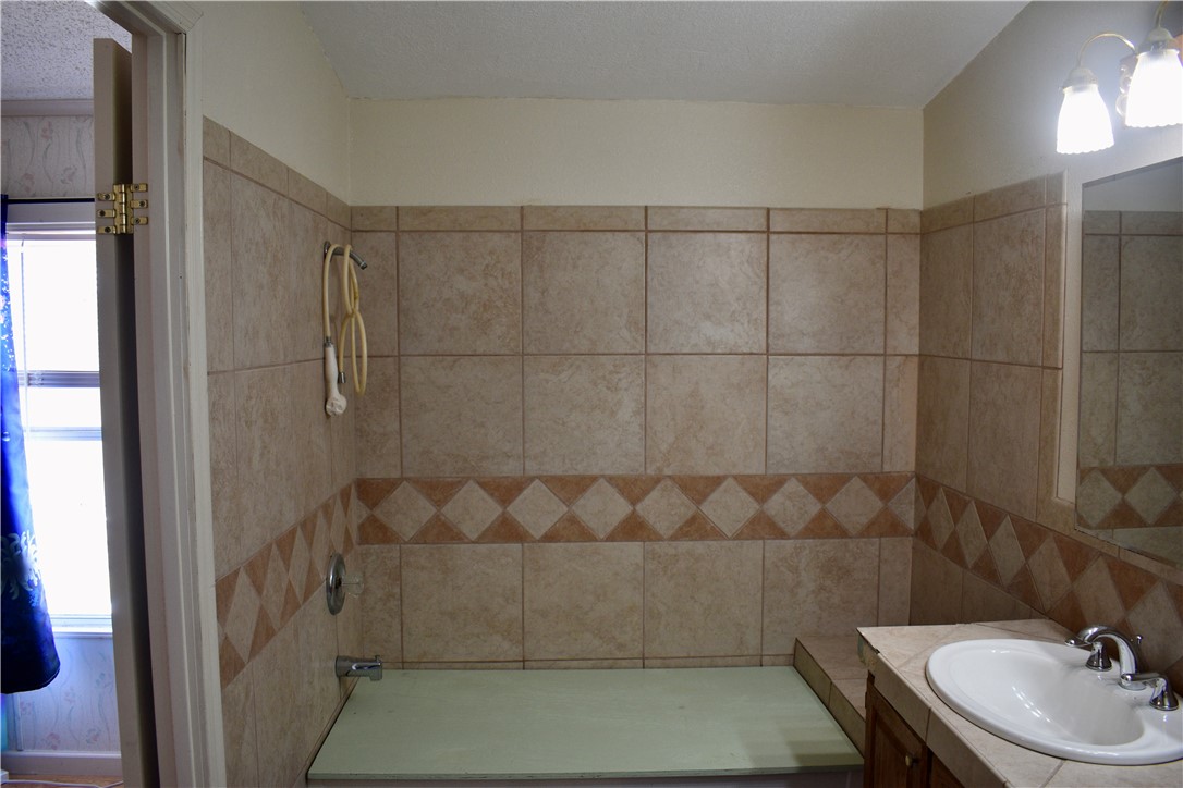 25051 Lake Shore Drive Mathis, TX 78368 - Photo 33 of 40 a bathroom with a sink toilet and shower