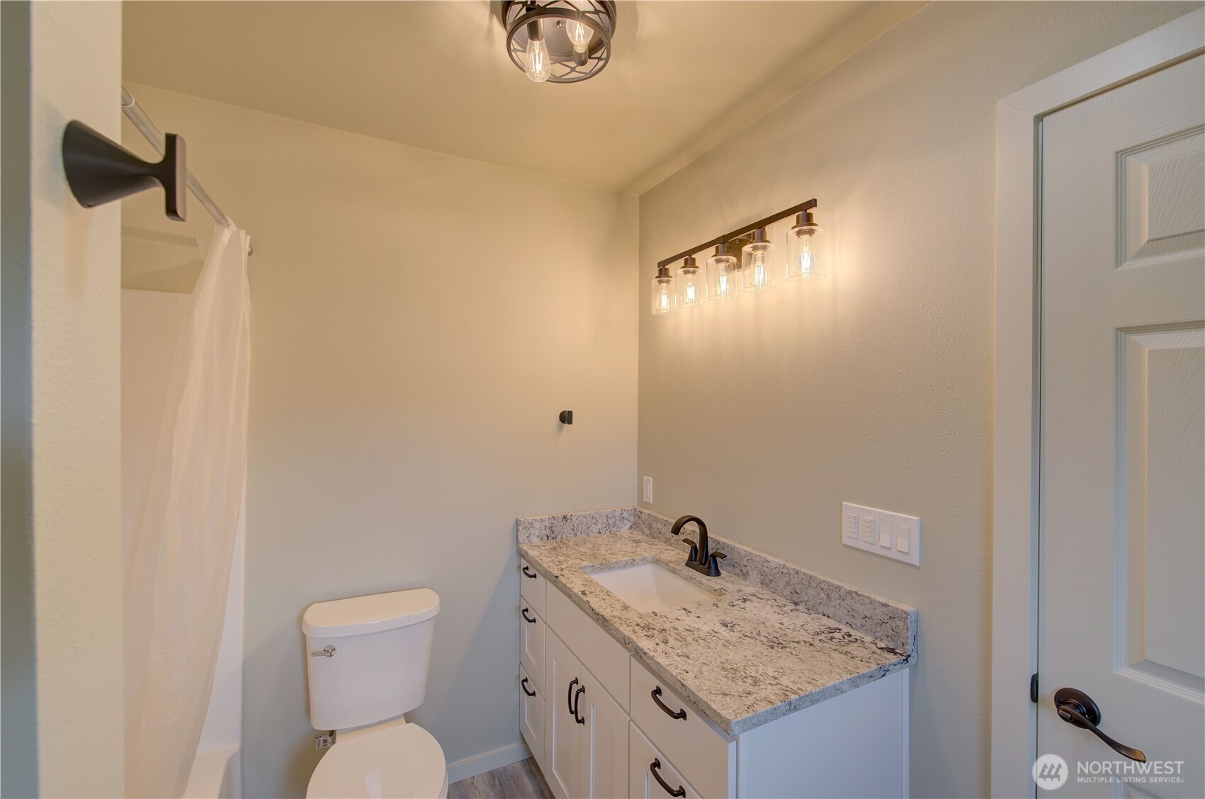 1365 Dolan Street Raymond, WA 98577 - Photo 15 of 24 a bathroom with a granite countertop sink toilet and shower