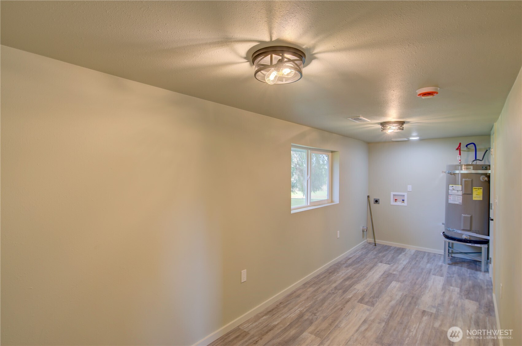 1365 Dolan Street Raymond, WA 98577 - Photo 16 of 24 wooden floor in an empty room with a window