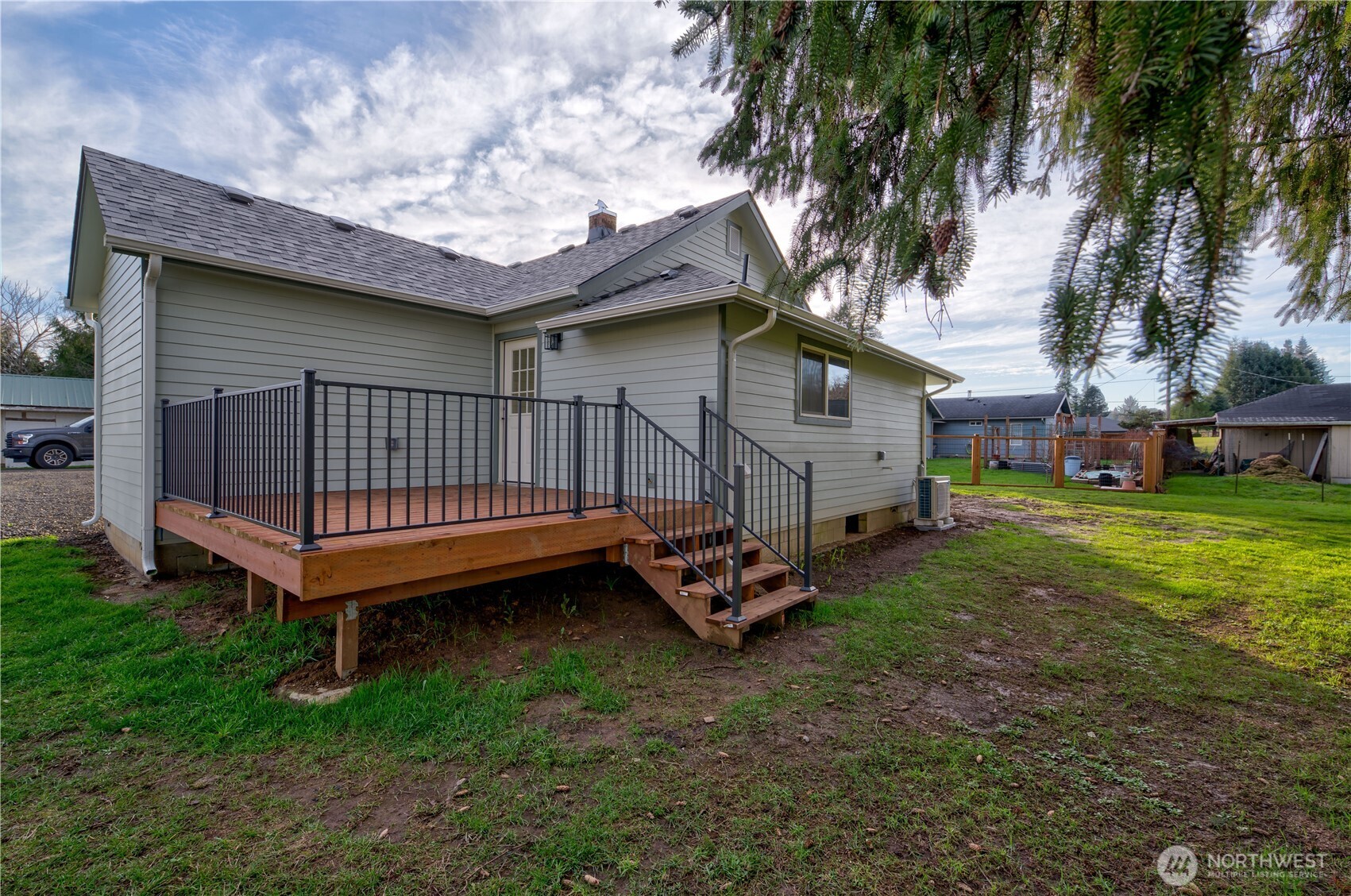 1365 Dolan Street Raymond, WA 98577 - Photo 17 of 24 a view of a house with a yard and deck area under a large tree