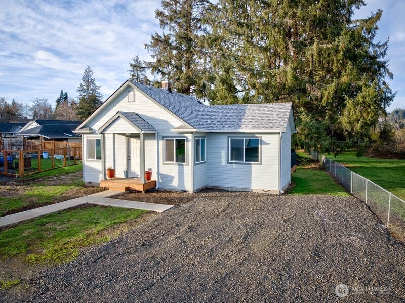 1365 Dolan Street Raymond, WA 98577 - Photo 2 of 24 a front view of a house with patio and garden