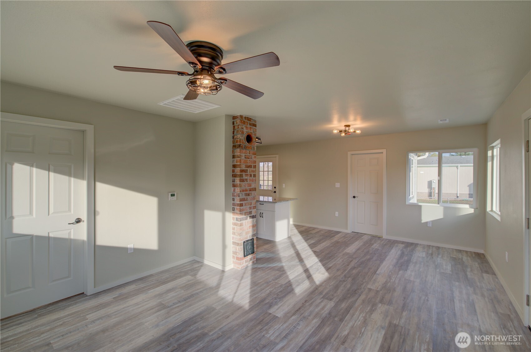 1365 Dolan Street Raymond, WA 98577 - Photo 6 of 24 a view of empty room with wooden floor and fan