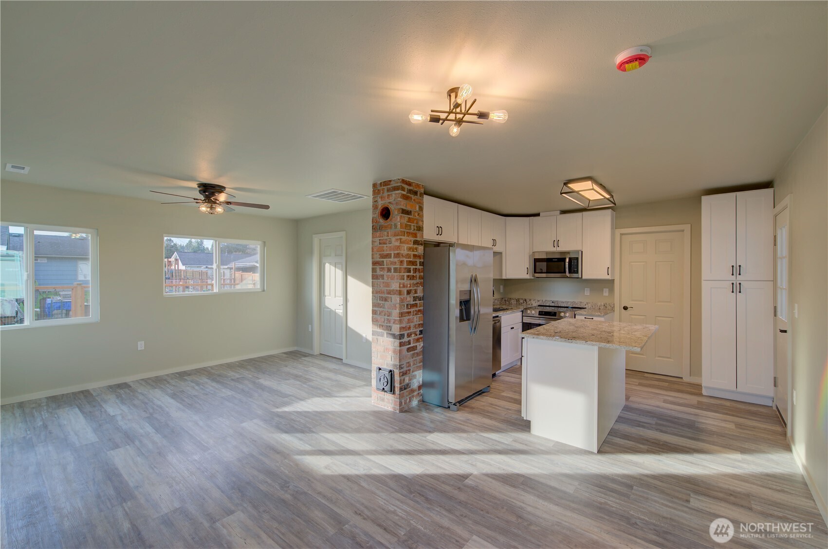 1365 Dolan Street Raymond, WA 98577 - Photo 8 of 24 a view of a kitchen with stainless steel appliances kitchen island hardwood floor and a sink