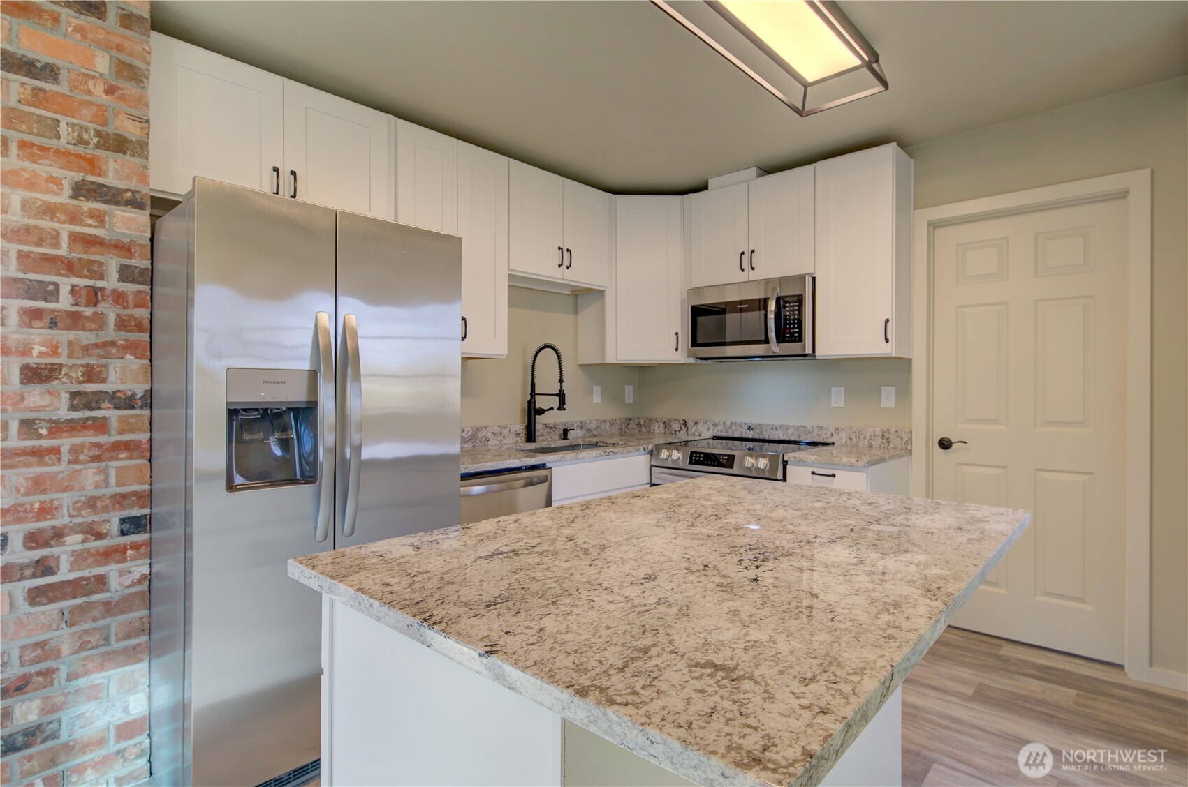 1365 Dolan Street Raymond, WA 98577 - Photo 9 of 24 a kitchen with stainless steel appliances granite countertop a sink a stove and a refrigerator