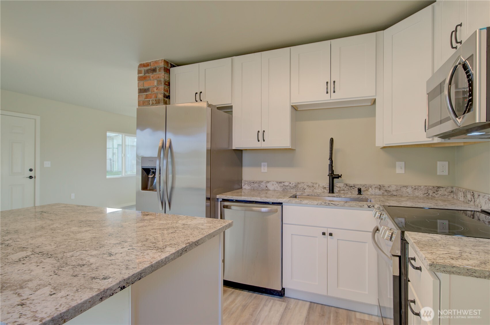 1365 Dolan Street Raymond, WA 98577 - Photo 10 of 24 a kitchen with stainless steel appliances granite countertop a sink stove and refrigerator
