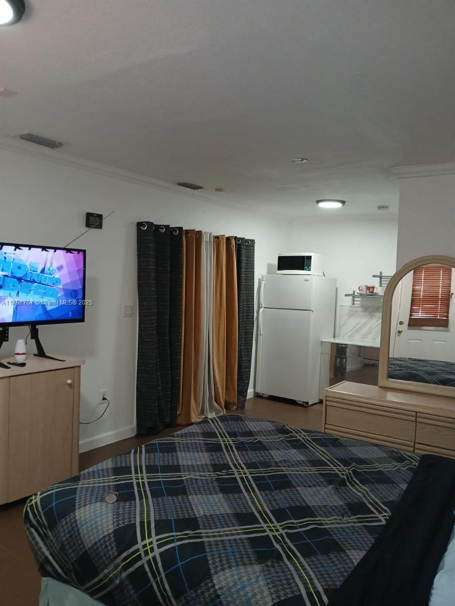 Miami-Dade County Miami, FL 33157 - Photo 4 of 9 a living room with a couch and a flat screen tv