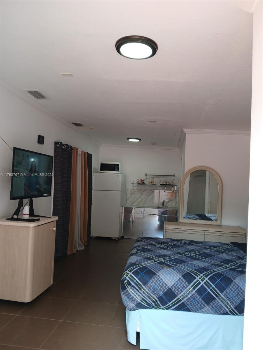 Miami-Dade County Miami, FL 33157 - Photo 6 of 9 a living room with furniture and a flat screen tv