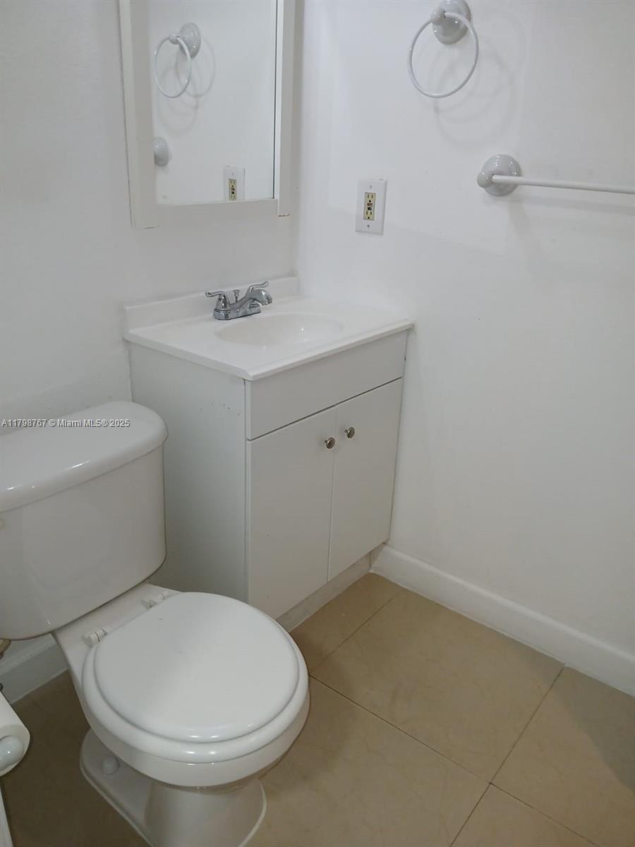 Miami-Dade County Miami, FL 33157 - Photo 7 of 9 a bathroom with a toilet sink and mirror