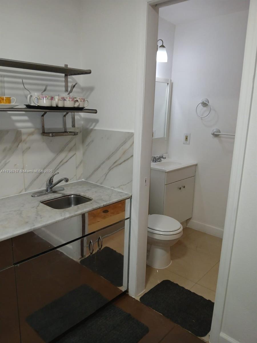 Miami-Dade County Miami, FL 33157 - Photo 8 of 9 a bathroom with a sink a toilet and a mirror