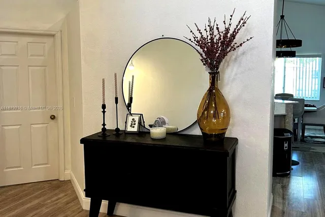a view of a workspace room with wooden floor table and chair