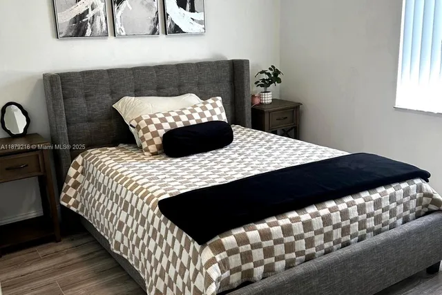 a bedroom with a bed and a window