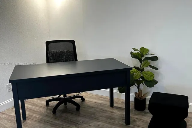 a table with a chair a lamp and a potted plant