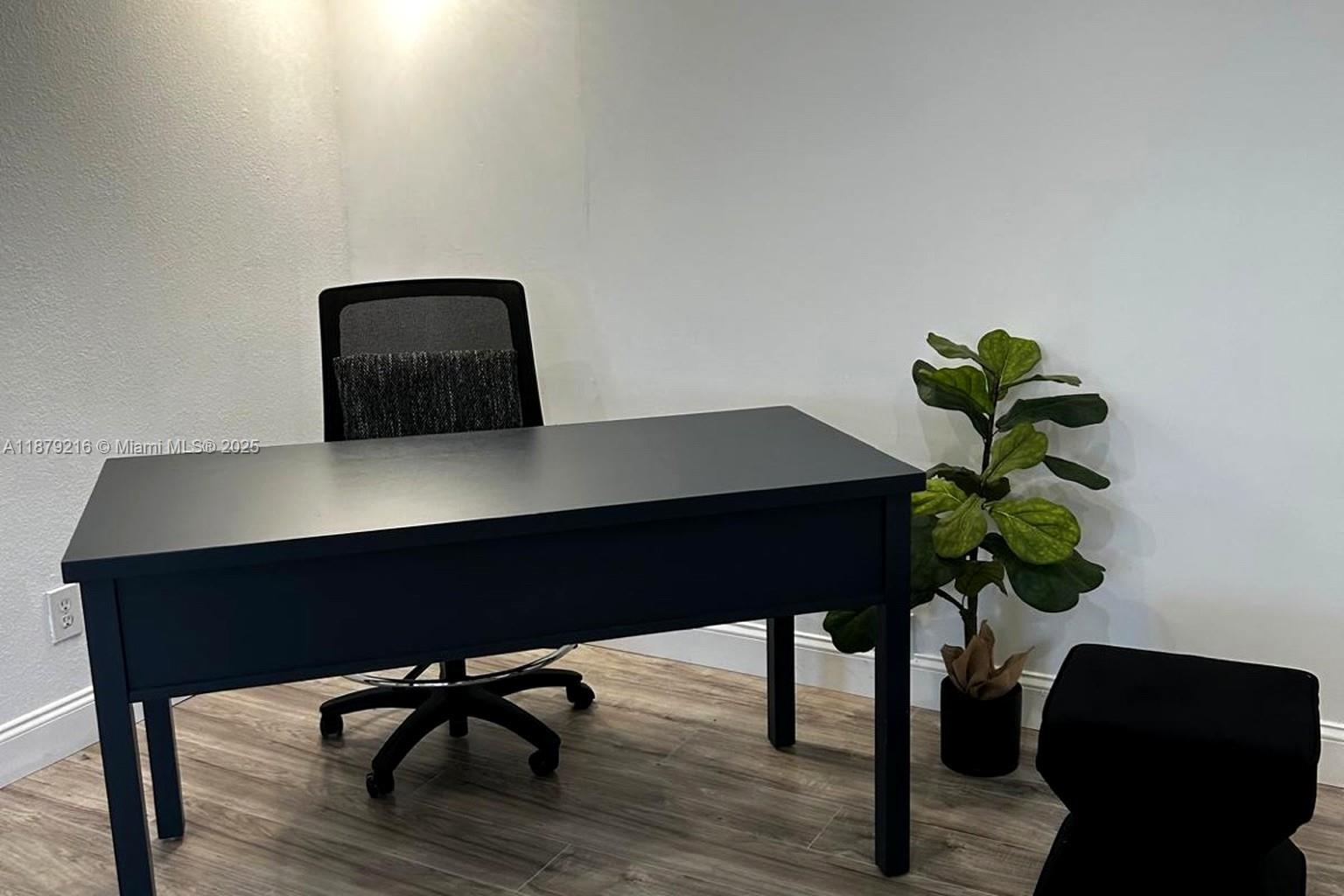 13221 Southwest 53rd Street Miramar, FL 33027 - Photo 23 of 24 a table with a chair a lamp and a potted plant