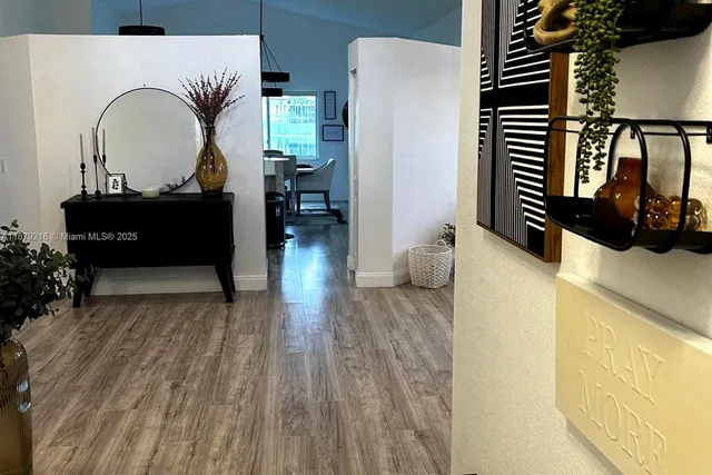 a view of living room with furniture and wooden floor