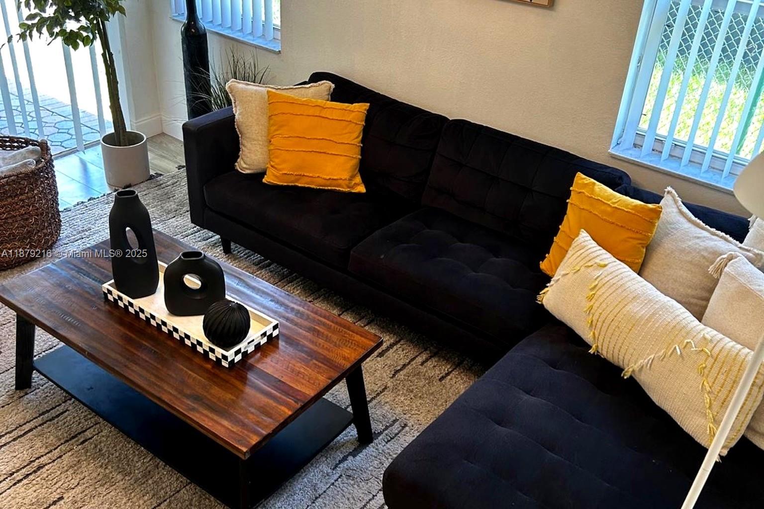 13221 Southwest 53rd Street Miramar, FL 33027 - Photo 6 of 24 a living room with furniture and a flat screen tv