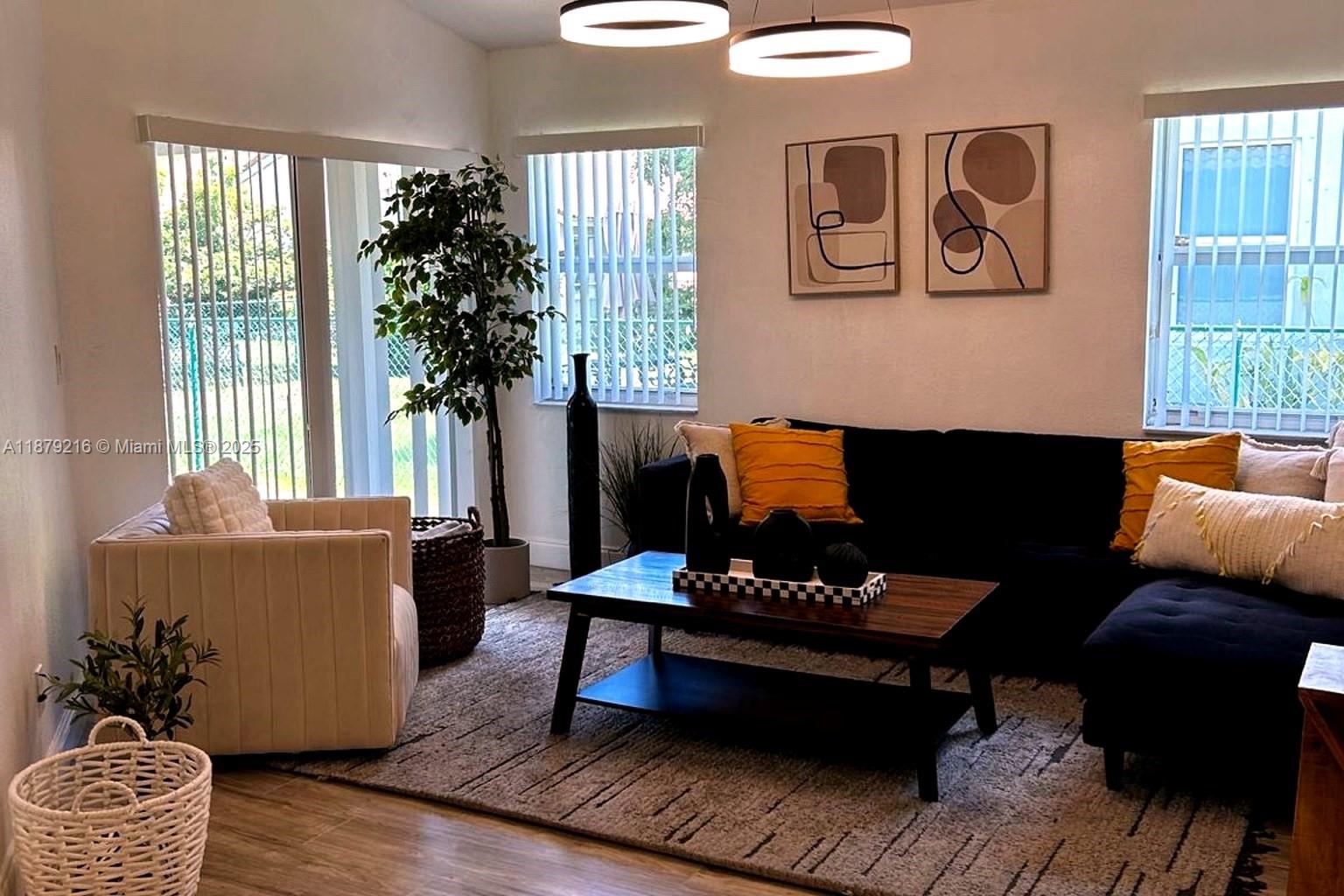 13221 Southwest 53rd Street Miramar, FL 33027 - Photo 7 of 24 a living room with furniture and a potted plant