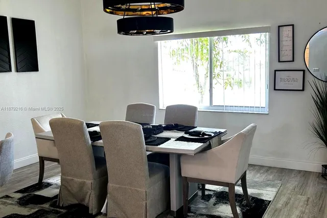 a work place with furniture a flat screen tv and a window