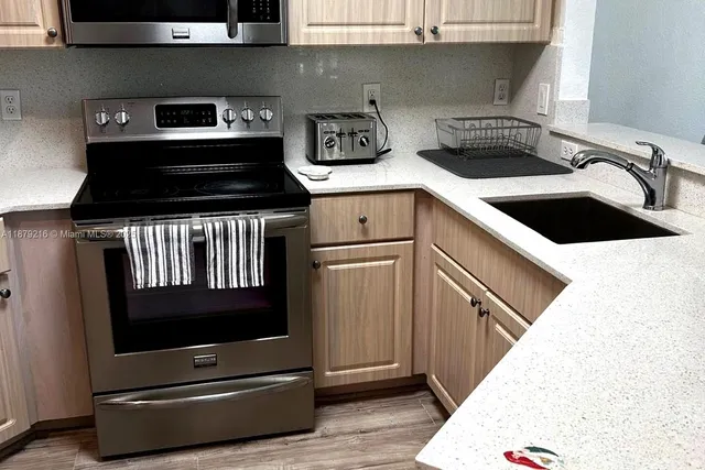 a kitchen with a stove and a microwave