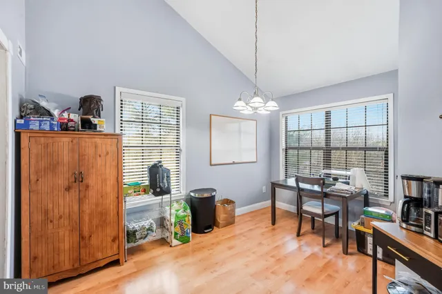 a work room with furniture and a large window