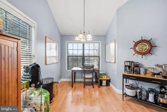 a living room with furniture a chandelier and a flat screen tv