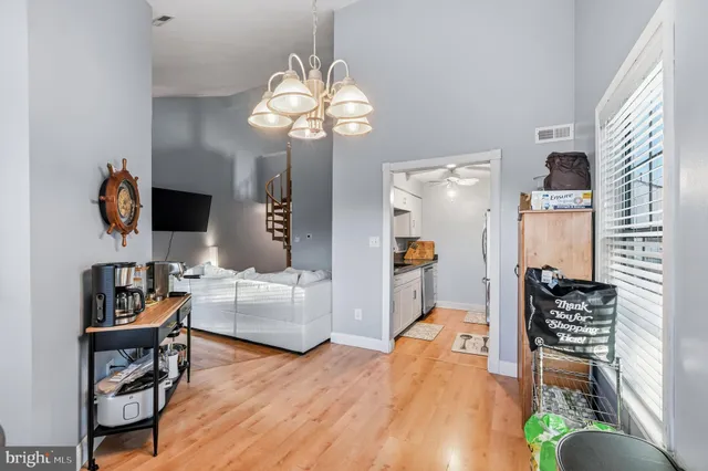 a kitchen with stainless steel appliances granite countertop a sink and a refrigerator