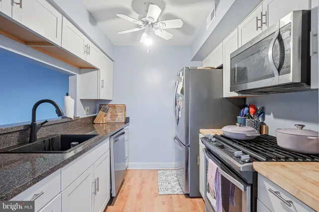 a kitchen with stainless steel appliances granite countertop a stove and a refrigerator