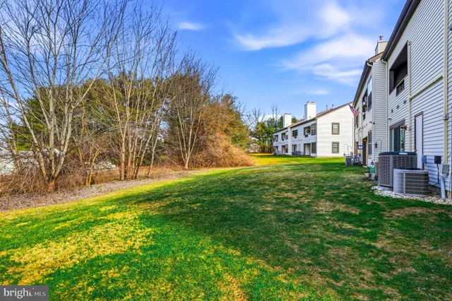 a view of a yard with a house in the background
