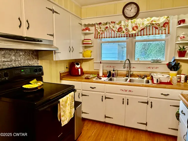 a kitchen with a sink cabinets and window