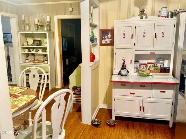 a kitchen with a refrigerator and cabinets