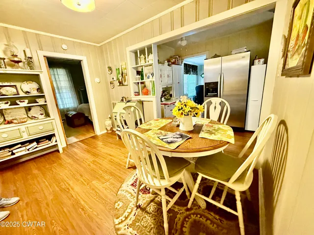 a view of a dining room with furniture and a chandelier