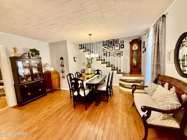 a dining room with furniture and wooden floor