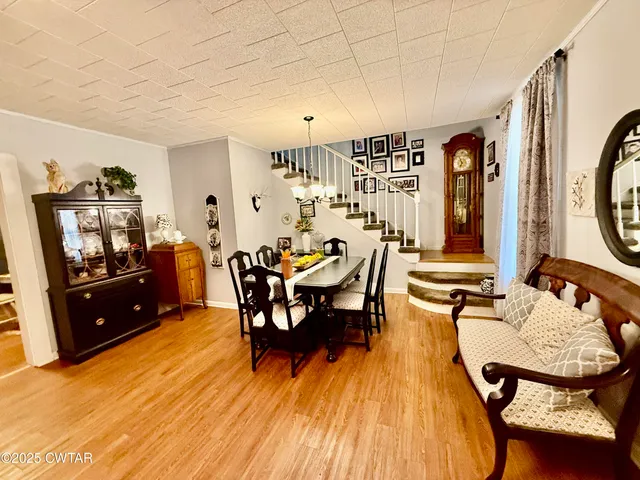 a dining room with furniture and wooden floor