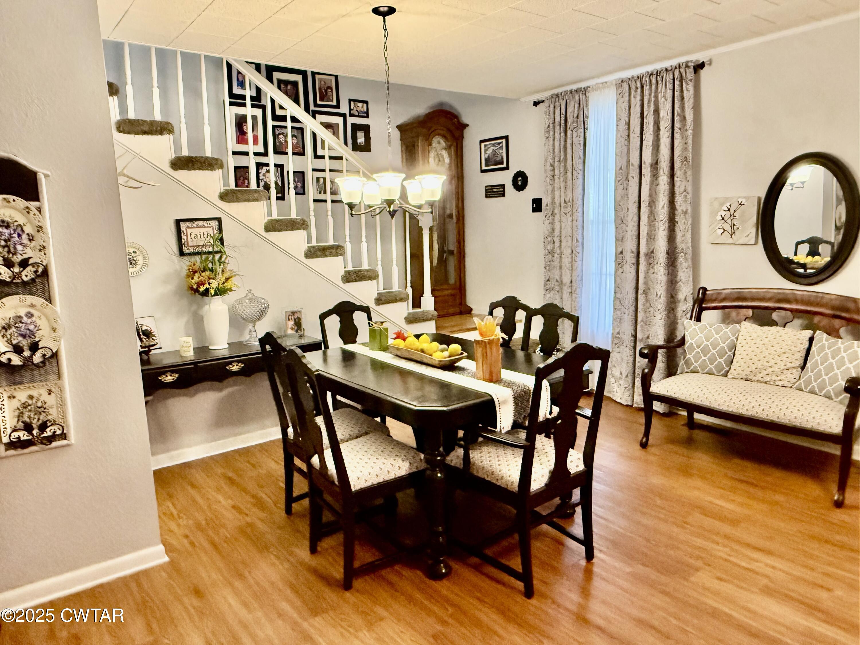 3121 Lantern Lane Union City, TN 38261 - Photo 10 of 19 a dining room with furniture a chandelier and wooden floor