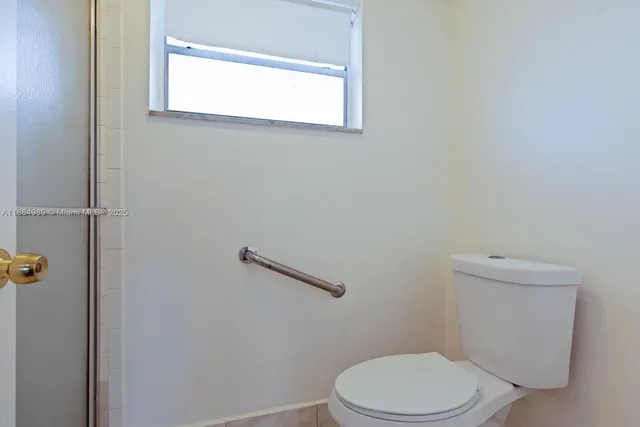 a white toilet sitting next to a bathroom sink