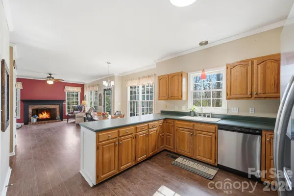 a open kitchen with sink cabinets and wooden floor
