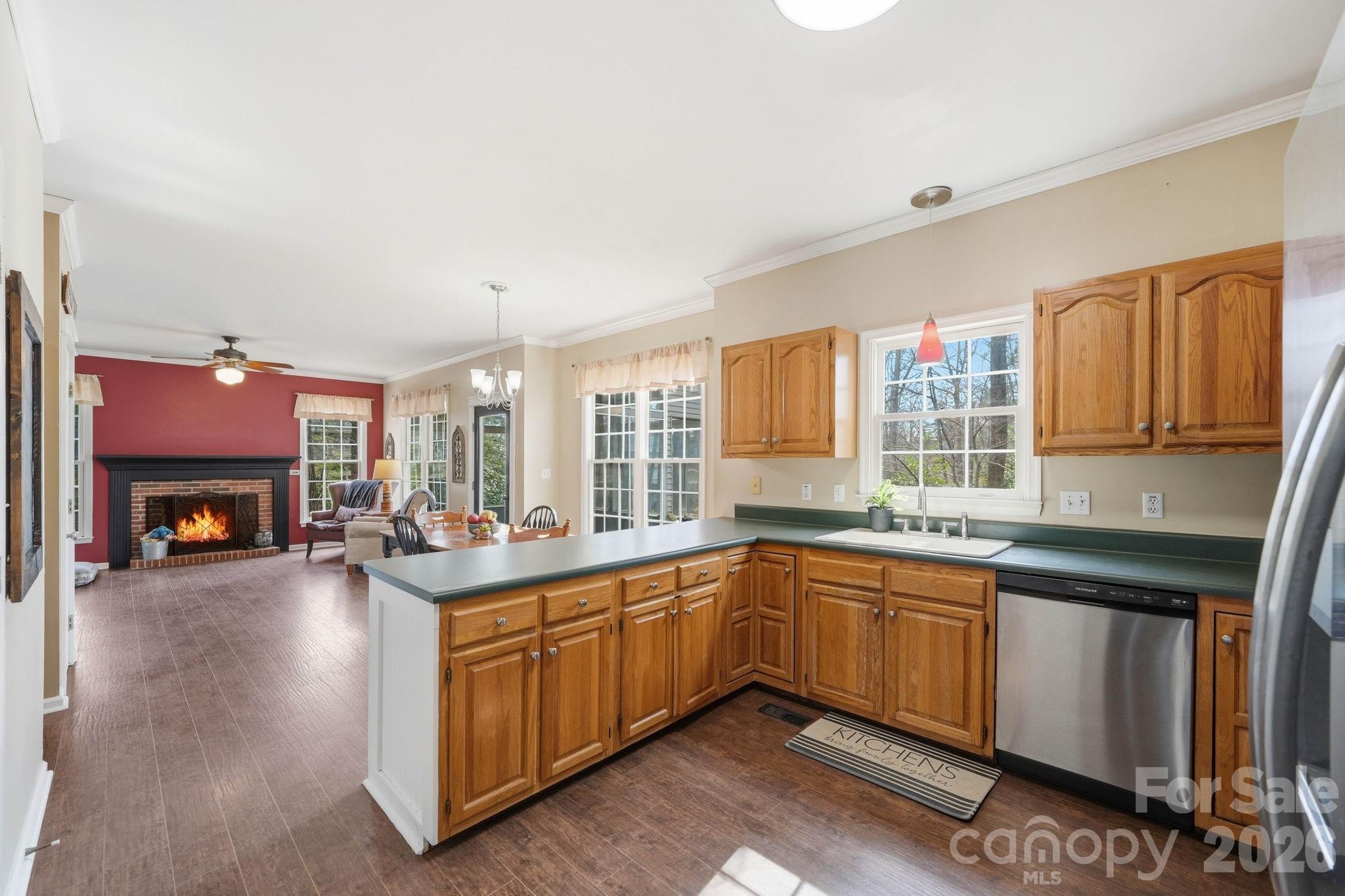 242 Windsor Forest Circle Fletcher, NC 28732 - Photo 15 of 43 a open kitchen with sink cabinets and wooden floor